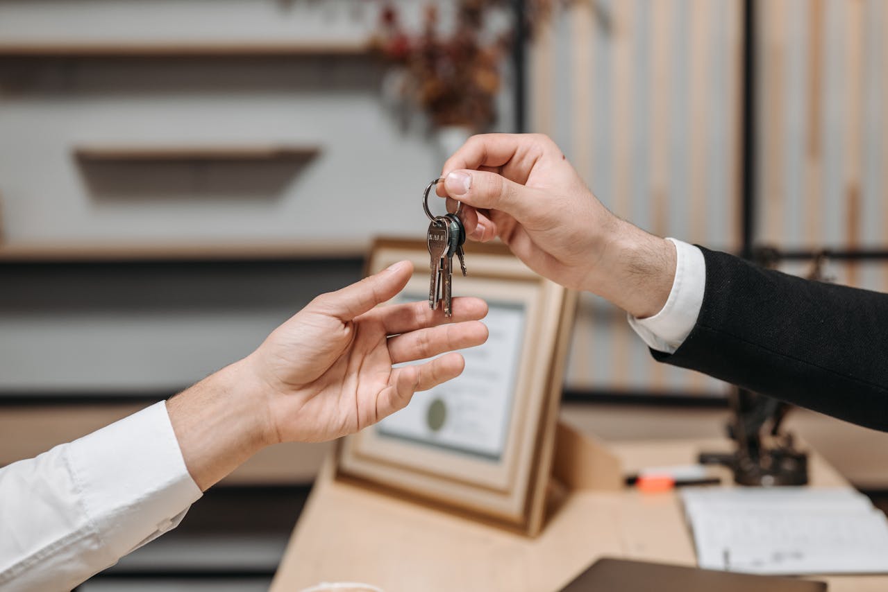 one-person-handing-keys-to-another-person one-person-handing-keys-to-another-person