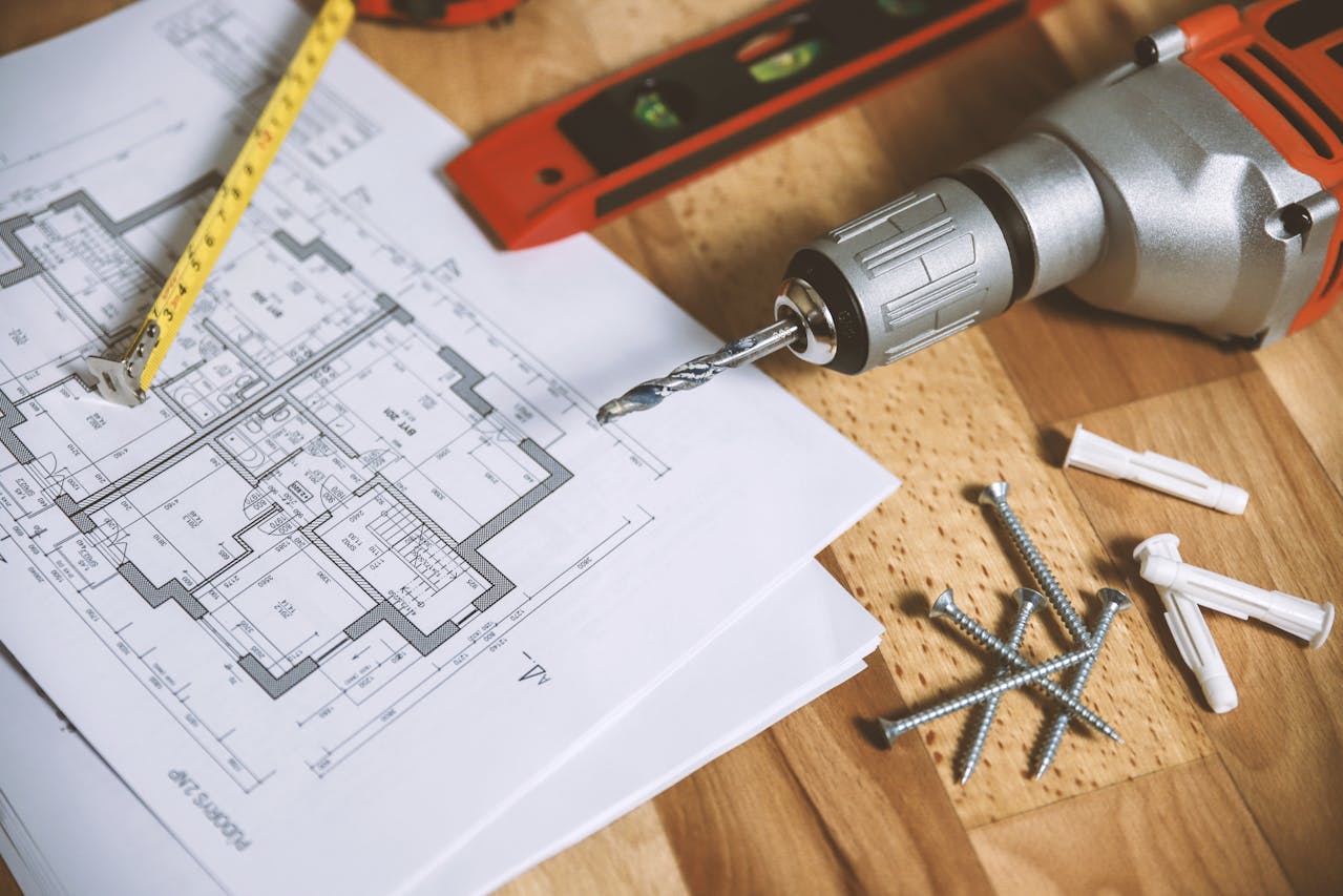 screwdriver-with-nails-and-home-building-plans